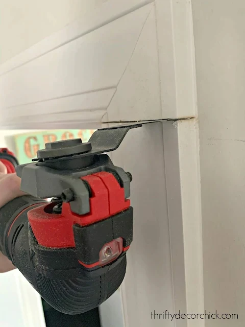cutting trim on wall with saw